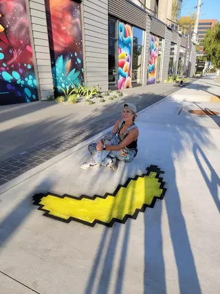 The chalk artist beside a 2D banana