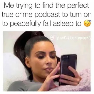 A woman looking at her phone in bed