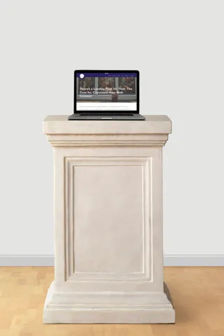 A laptop showcasing the Elevate My Brand website sits atop a pedestal in a well-lit museum