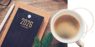 A 2026 planner sits next to a coffee cup